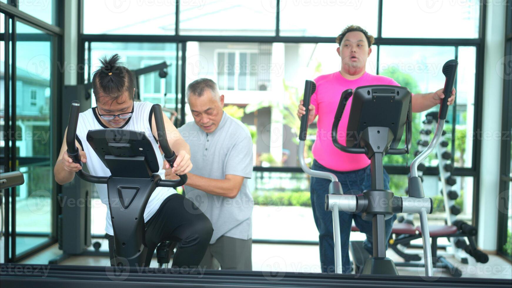 A family with an autistic child exercises together at the village clubhouse during the holidays photo