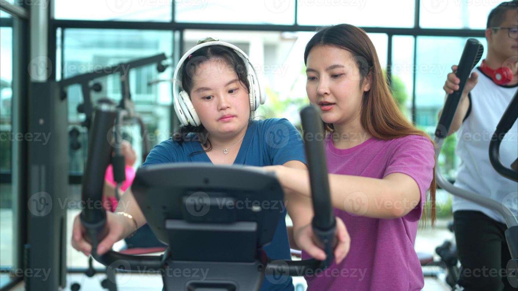 A family with an autistic child exercises together at the village clubhouse during the holidays photo