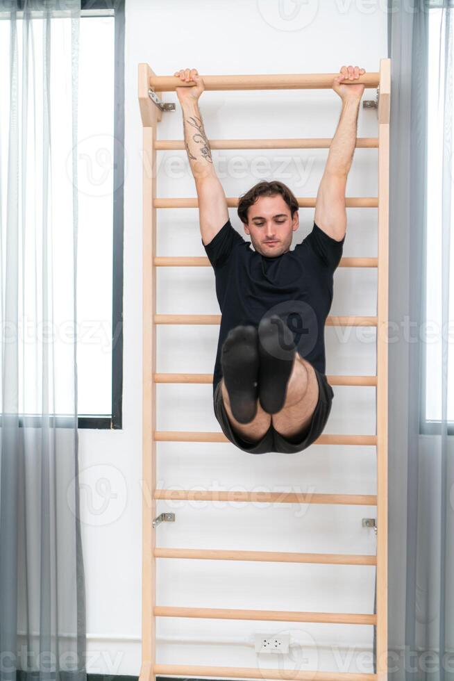 A young man doing cool down after pilates exercises class photo
