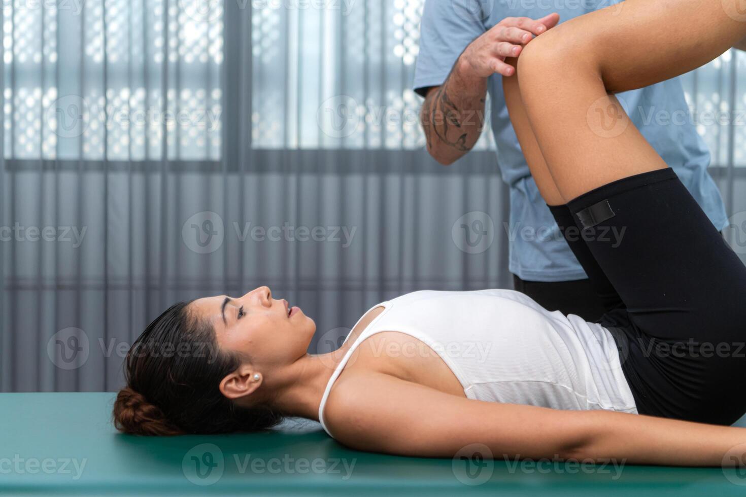 A young man and a young woman are doing pilates exercises on a pilates cadillac photo