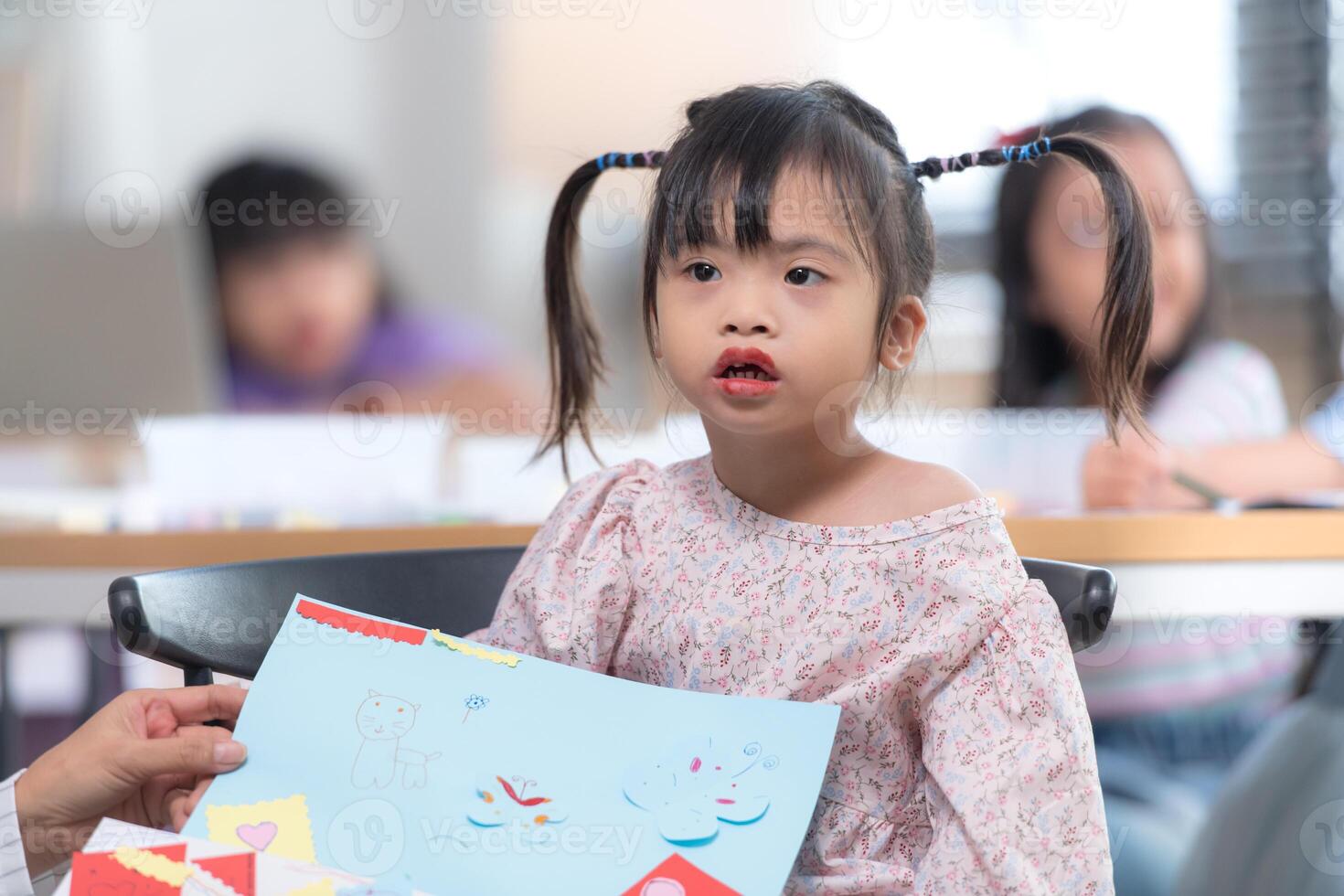 Portrait of special students doing learning activities in a special classroom photo