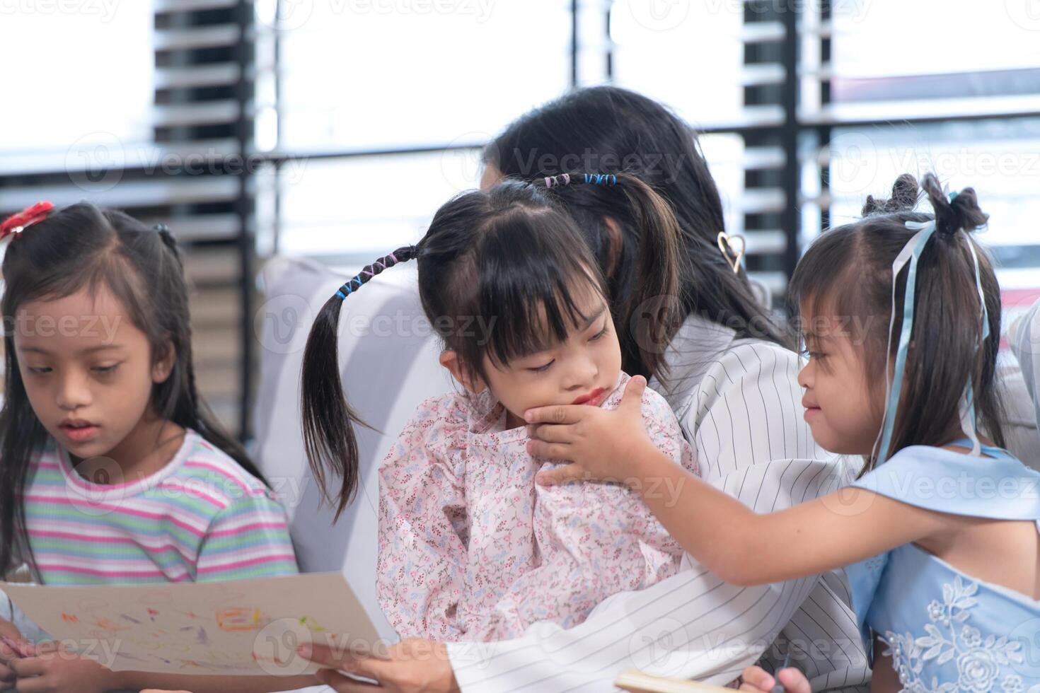 A group of special students doing learning activities in a special classroom photo