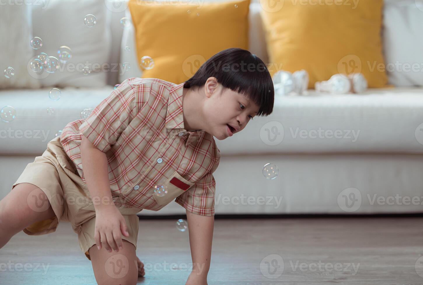 A special child having fun playing with a soap bubble bag in the living room of the house photo