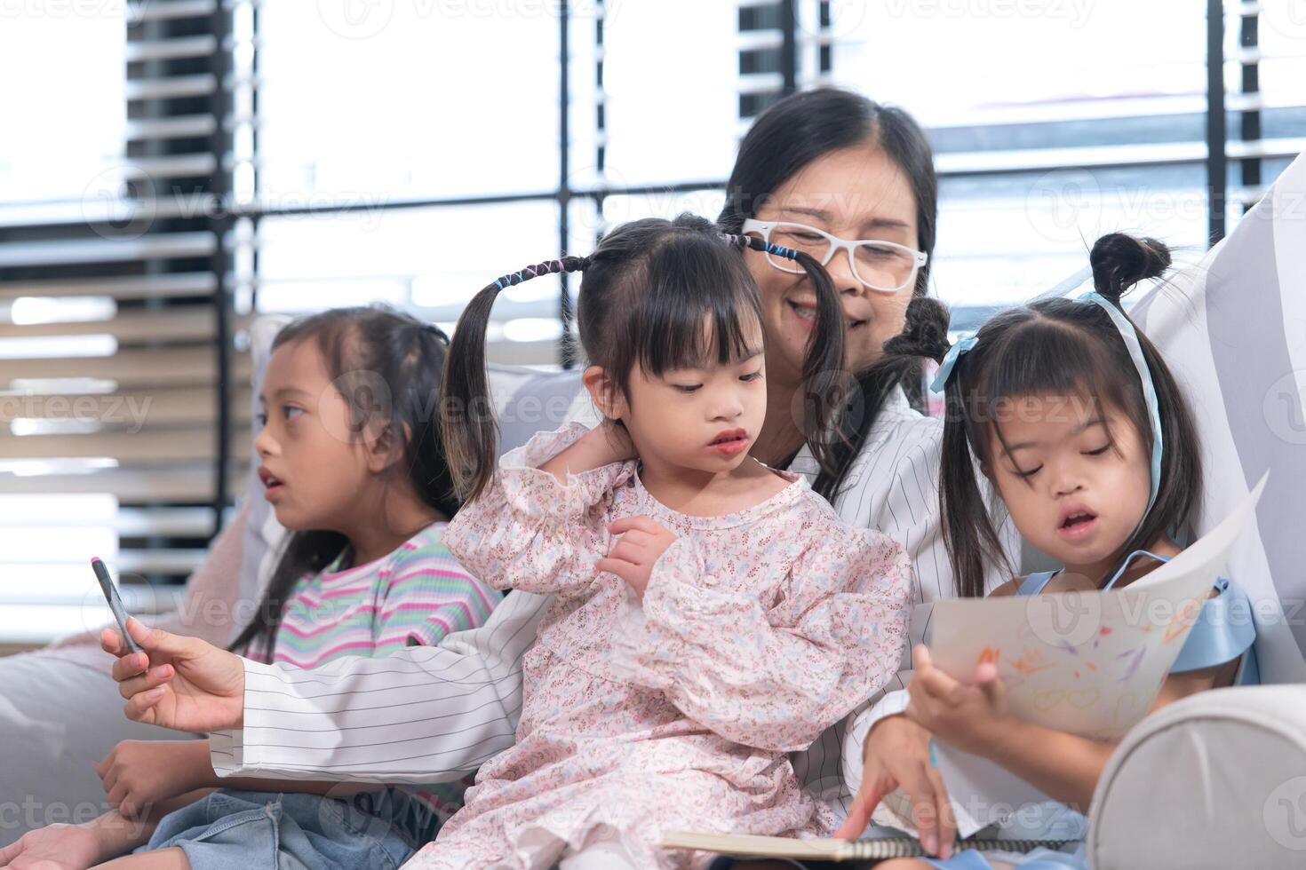 A group of special students doing learning activities in a special classroom photo