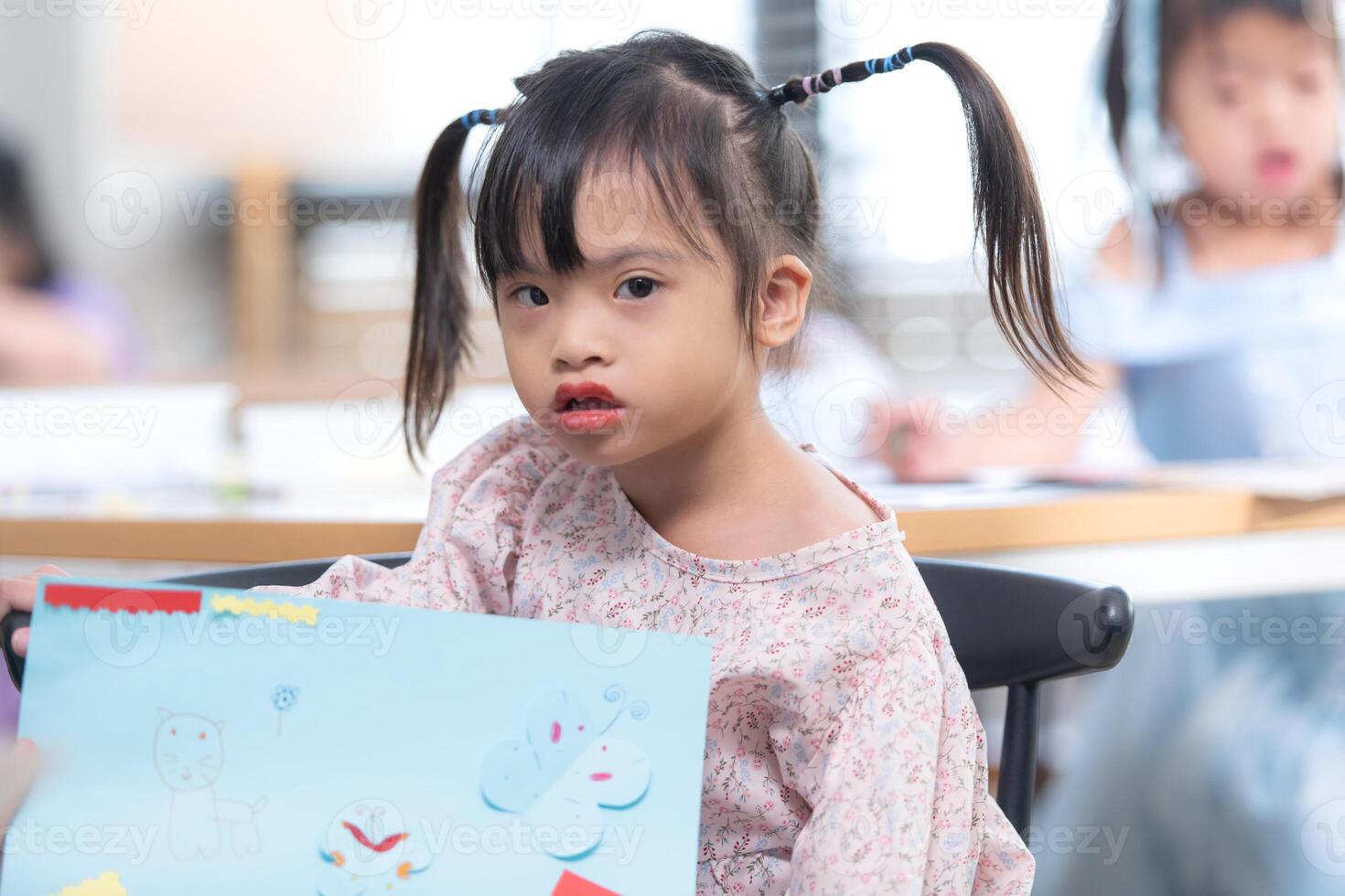 Portrait of special students doing learning activities in a special classroom photo