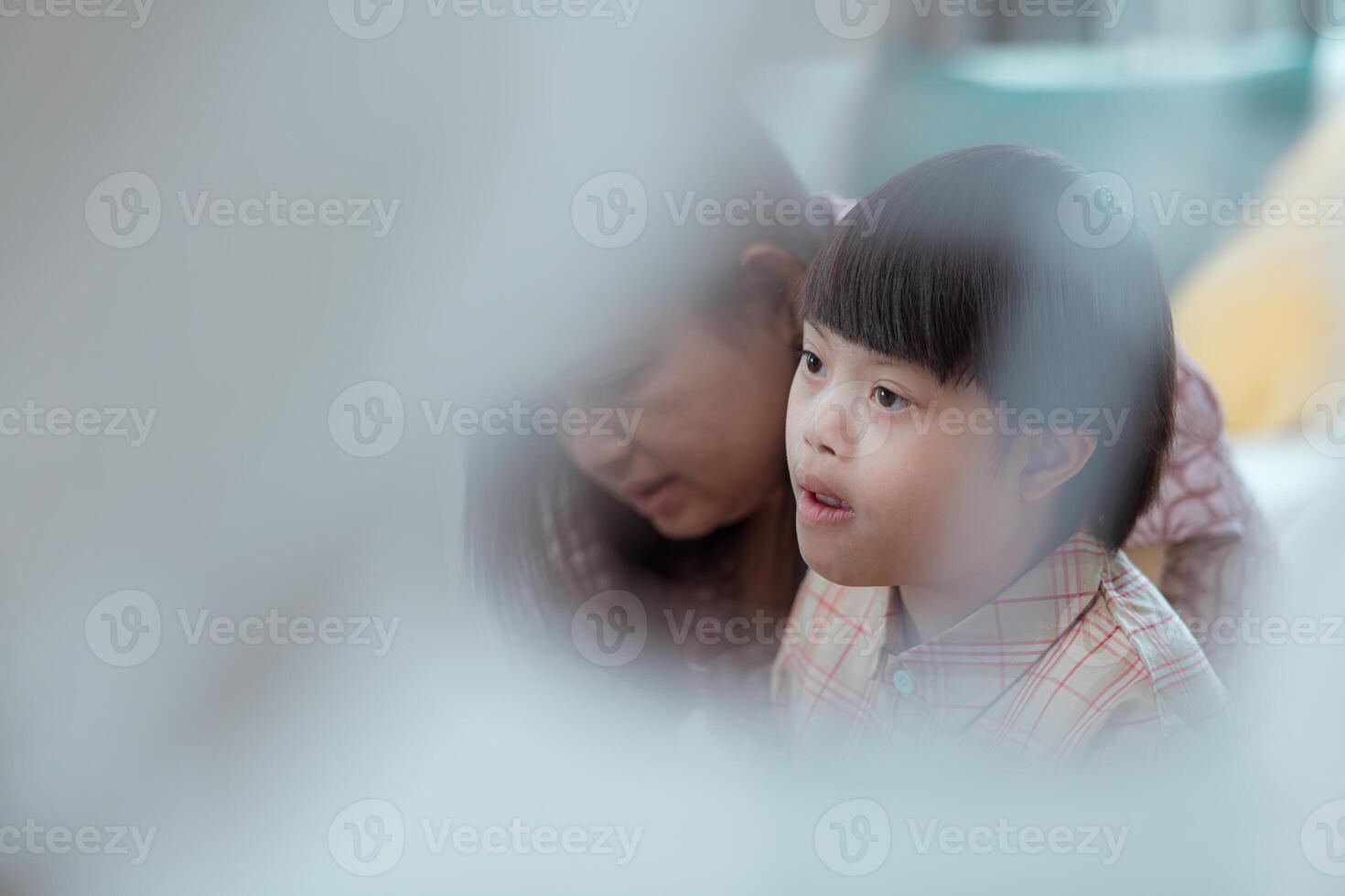 A special child and his mom having fun and relaxing on a holiday together in the living room of the house photo