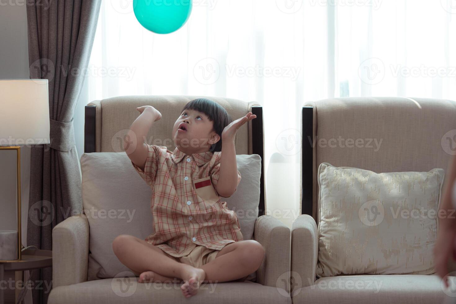 A special child relaxes on the sofa in the living room of the house photo