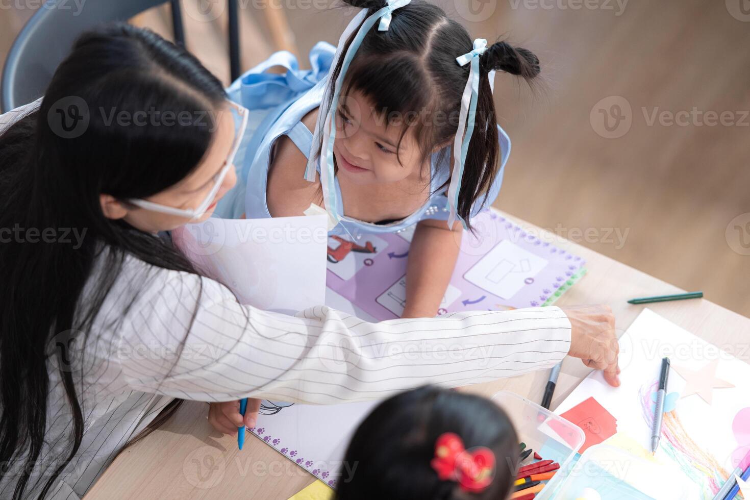 A group of special students doing learning activities in a special classroom photo