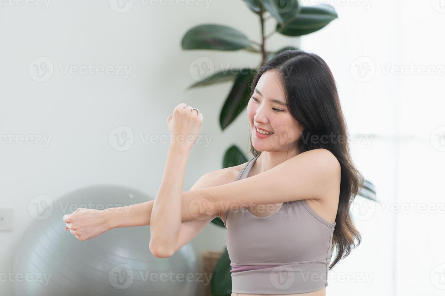 Asian young women doing yoga exercises during their holiday at home photo