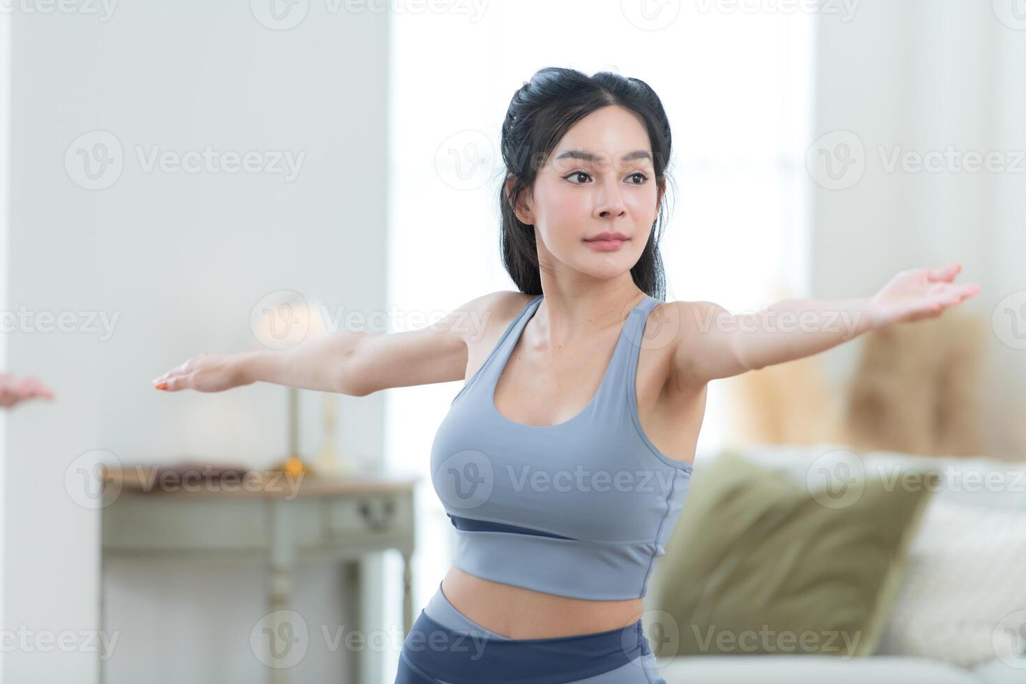 Asian young women doing yoga exercises during their holiday at home photo