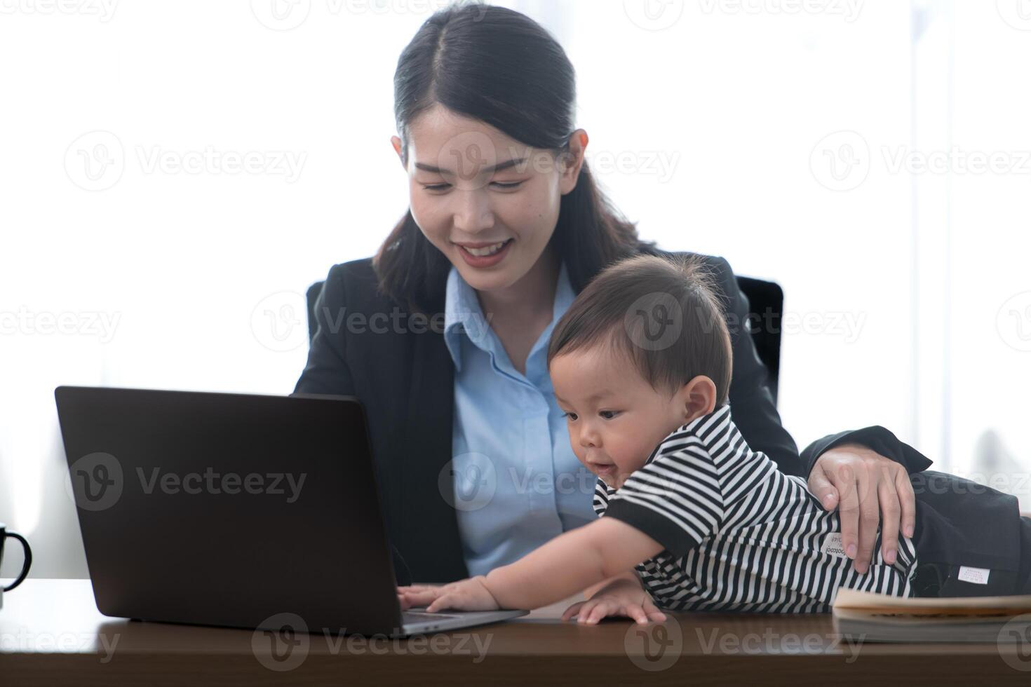 A business mother and his duty to take care of his children while working photo