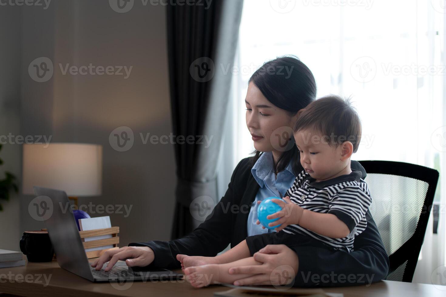 A business mother and his duty to take care of his children while working photo