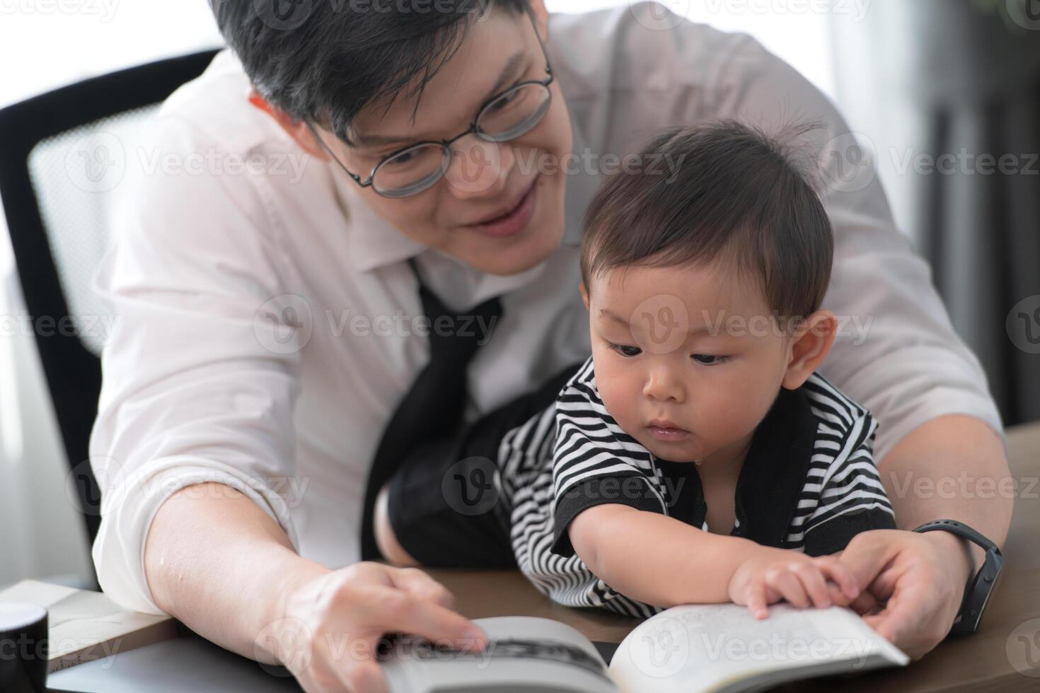 A business father and his duty to take care of his children while working photo