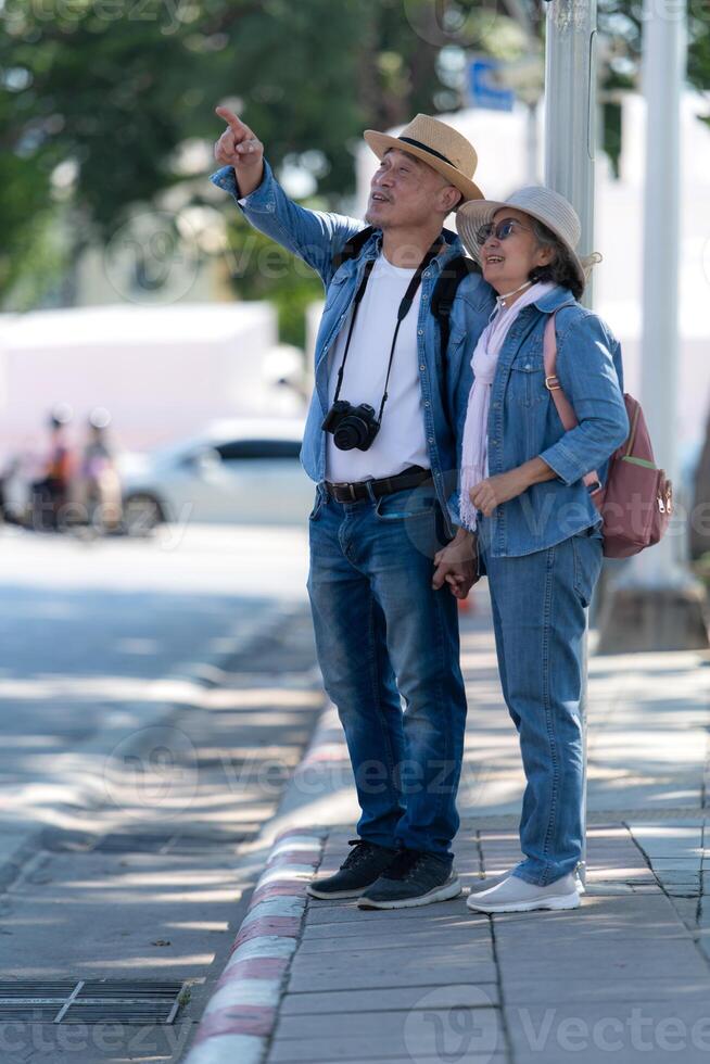An elderly couple walks around the street in the old city of Bangkok, Thailand. photo