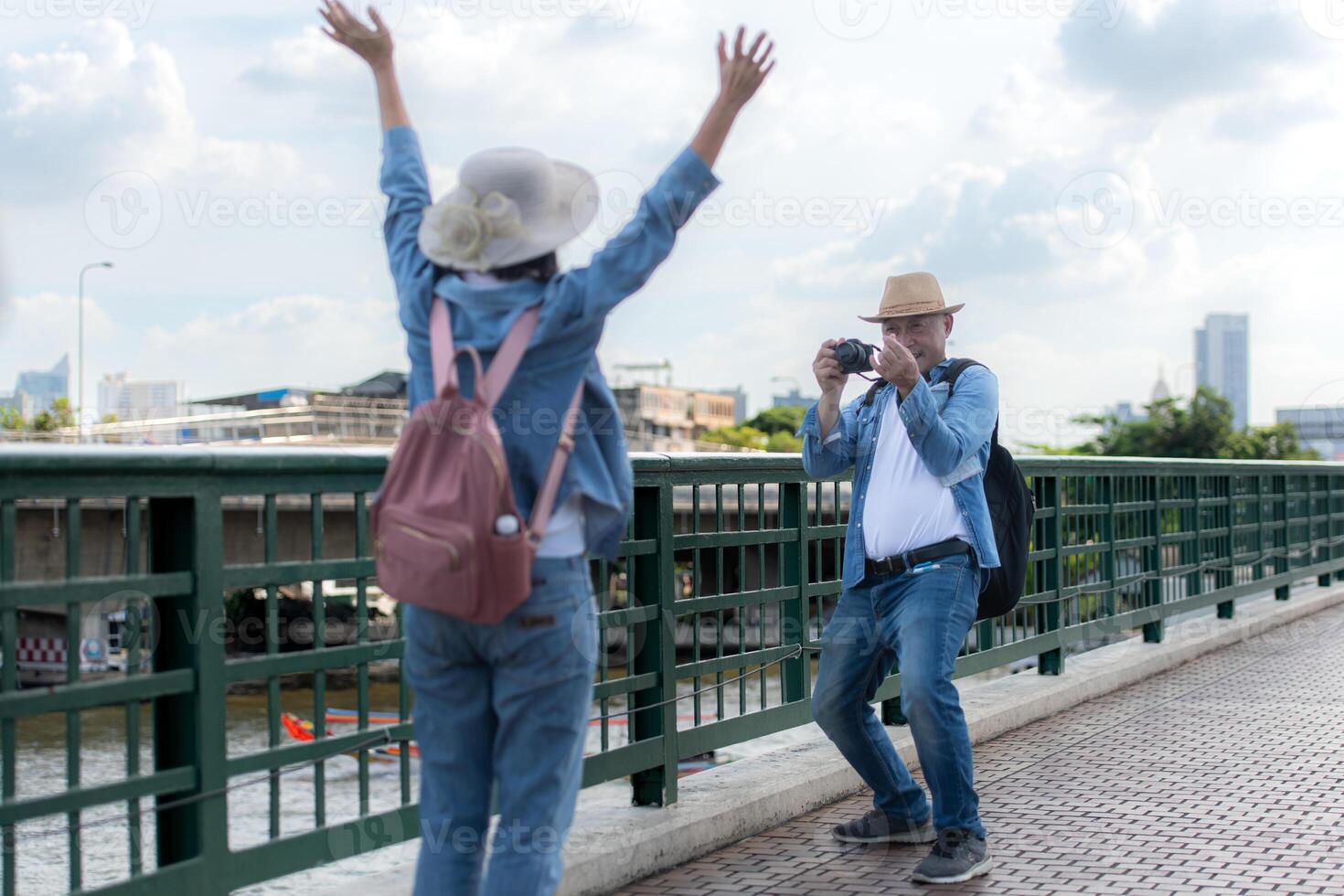 Elderly couples travel on the old iron bridge in Bangkok, Thailand photo