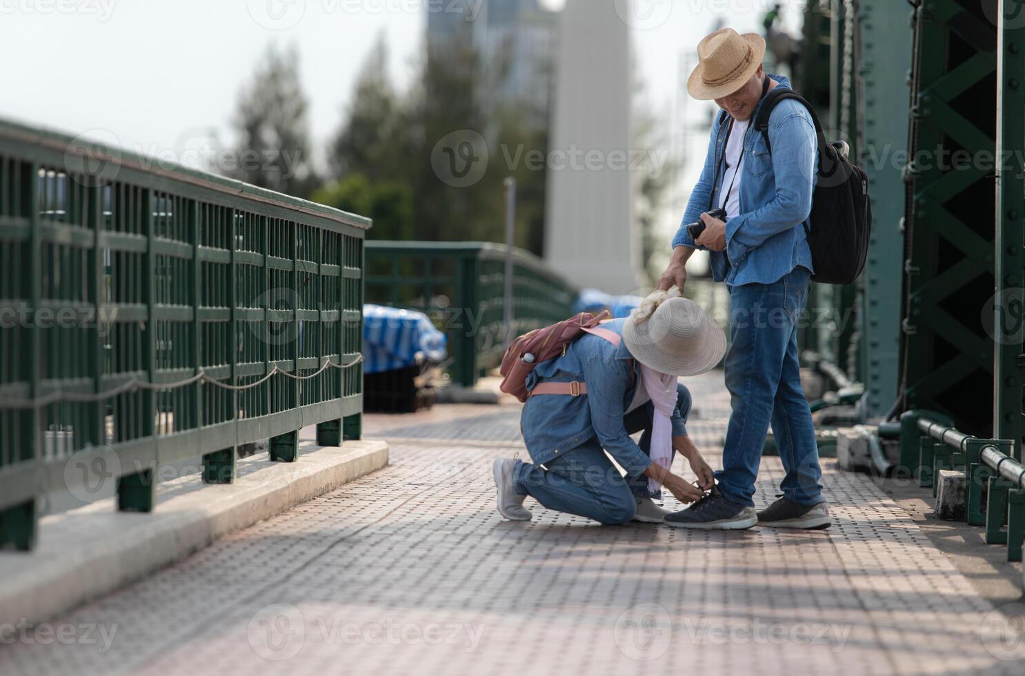 Elderly couples travel on the old iron bridge in Bangkok, Thailand photo