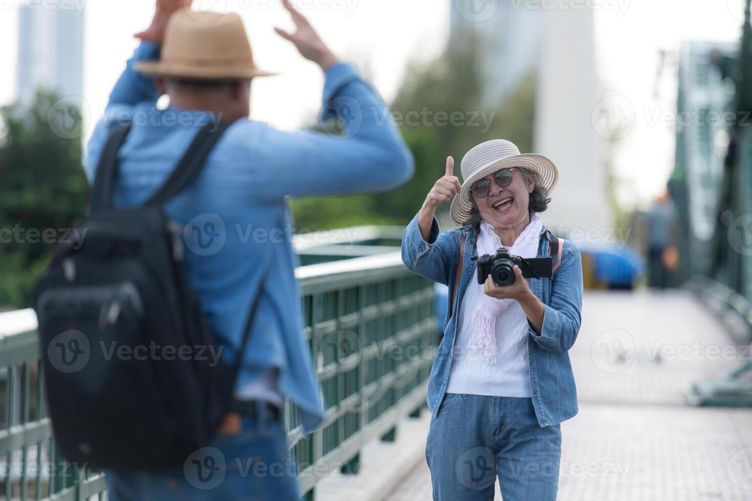 Elderly couples travel on the old iron bridge in Bangkok, Thailand photo