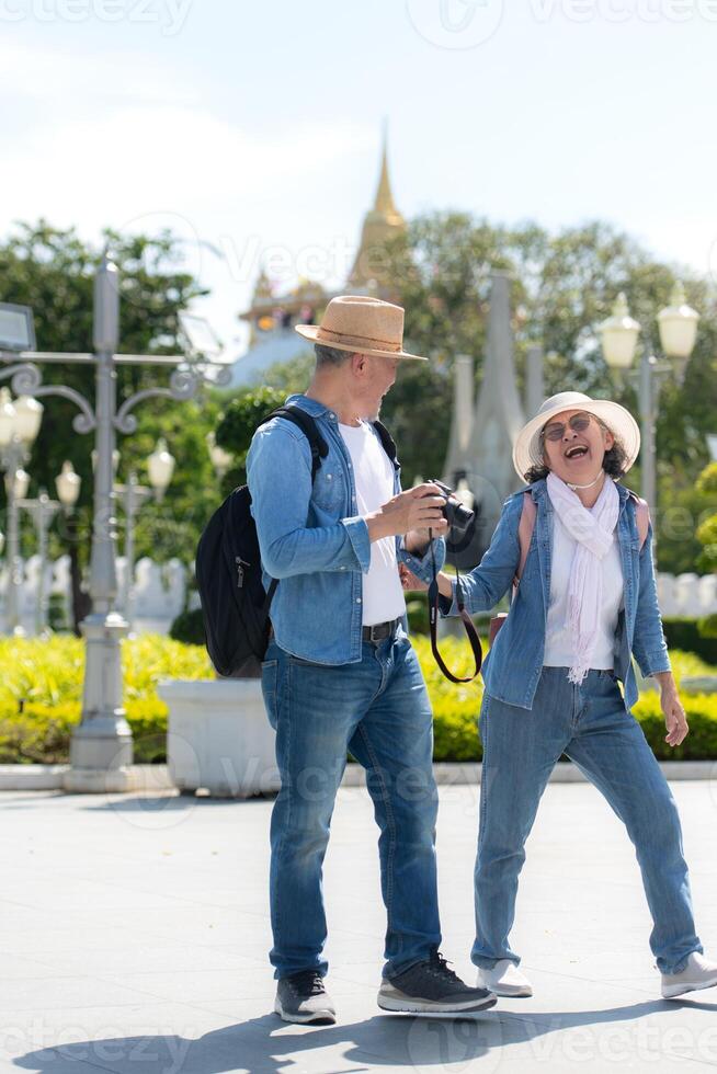 An elderly couple walks around the street in the old city of Bangkok, Thailand. photo