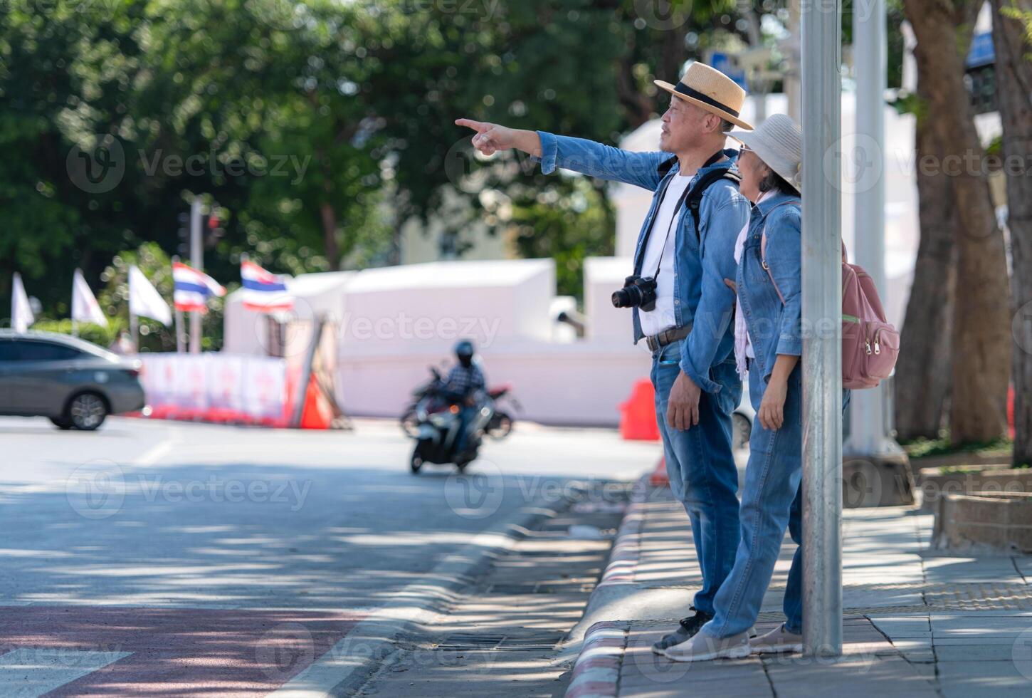 An elderly couple walks around the street in the old city of Bangkok, Thailand. photo