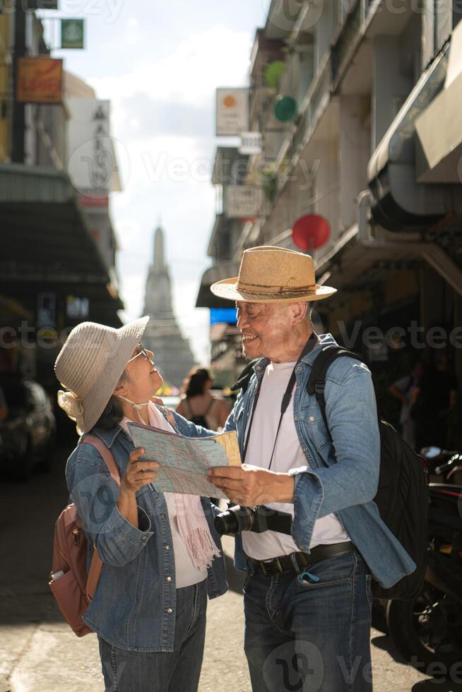 Elderly couples and their activities on the road at the end of the alley where there is a pagoda of Wat Arun, Thailand photo