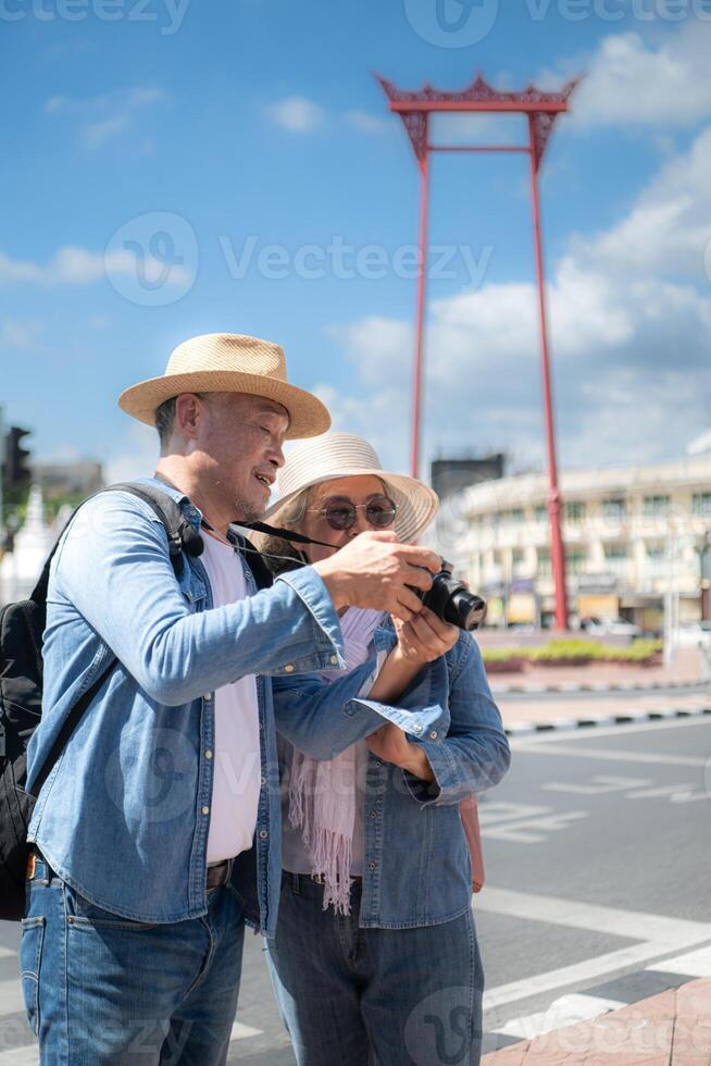 An elderly couple walks around the street in the old city of Bangkok, Thailand. photo