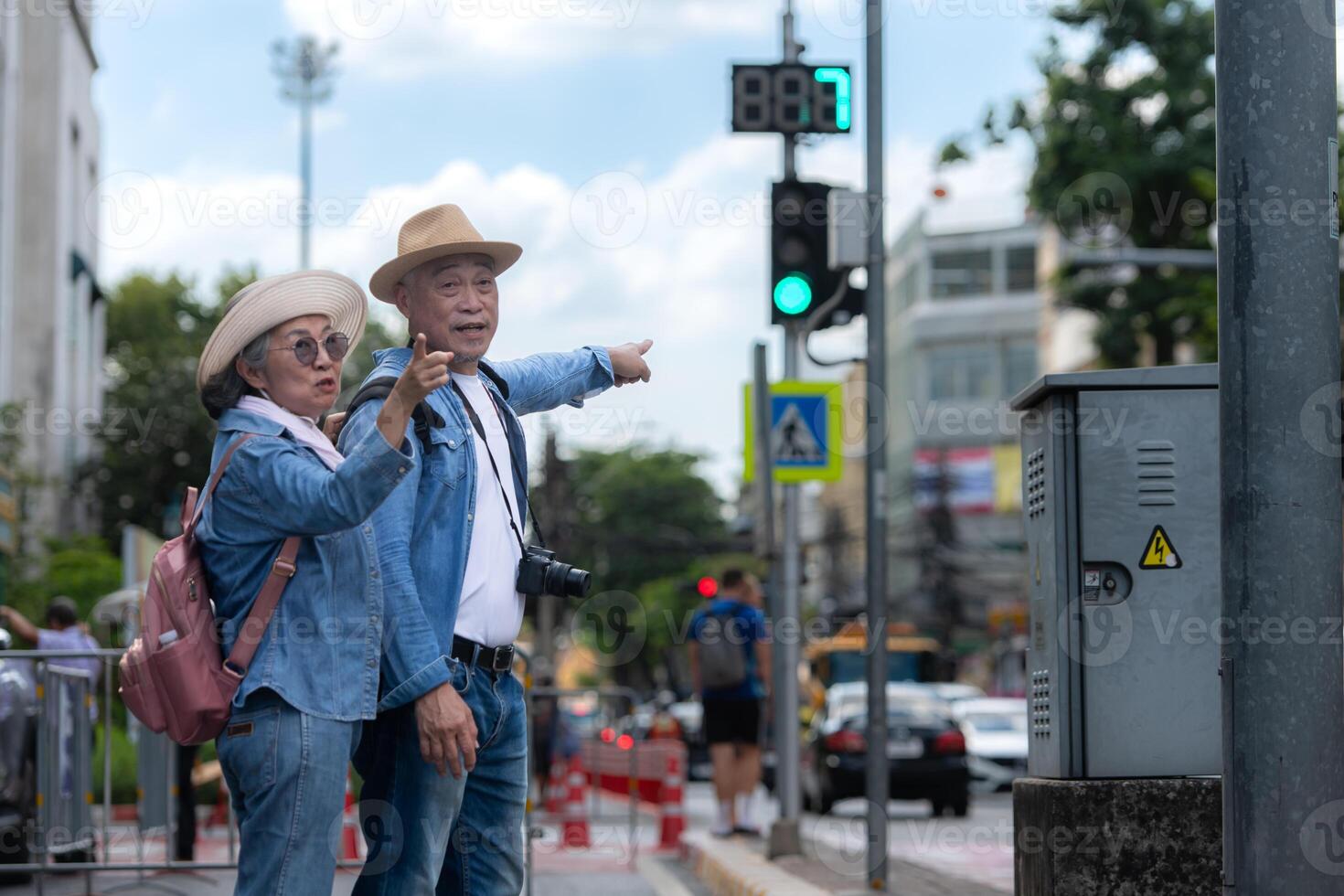 An elderly couple walks around the street in the old city of Bangkok, Thailand. photo