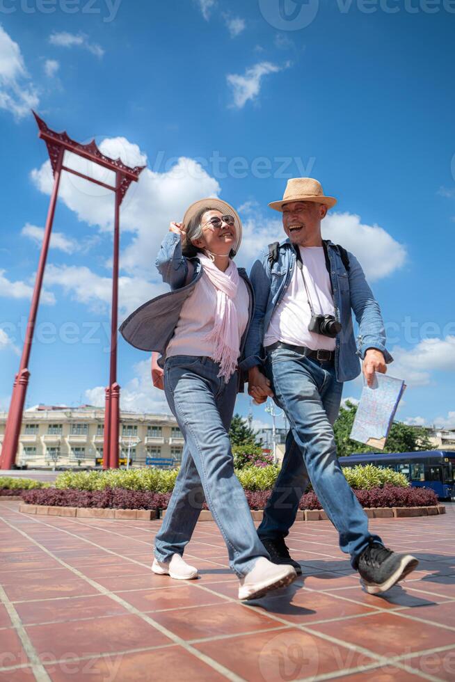 An elderly couple walks around the street in the old city of Bangkok, Thailand. photo