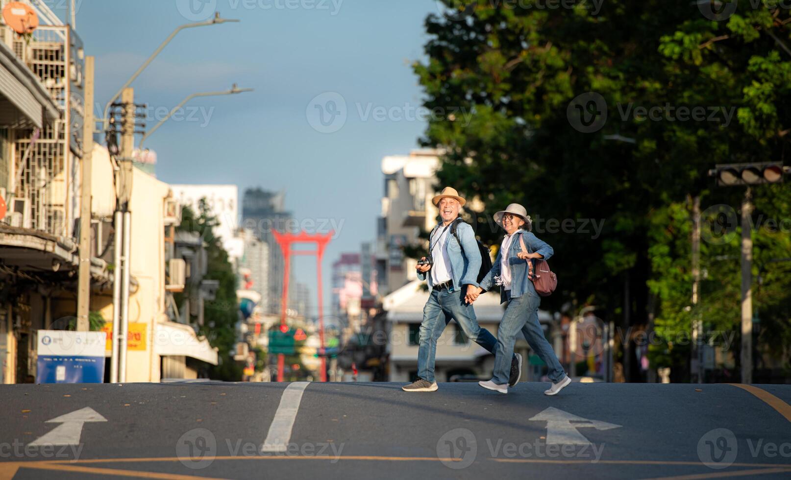 An elderly couple walks around the street in the old city of Bangkok, Thailand. photo