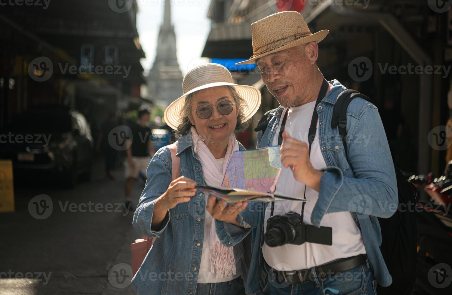 Elderly couples and their activities on the road at the end of the alley where there is a pagoda of Wat Arun, Thailand photo
