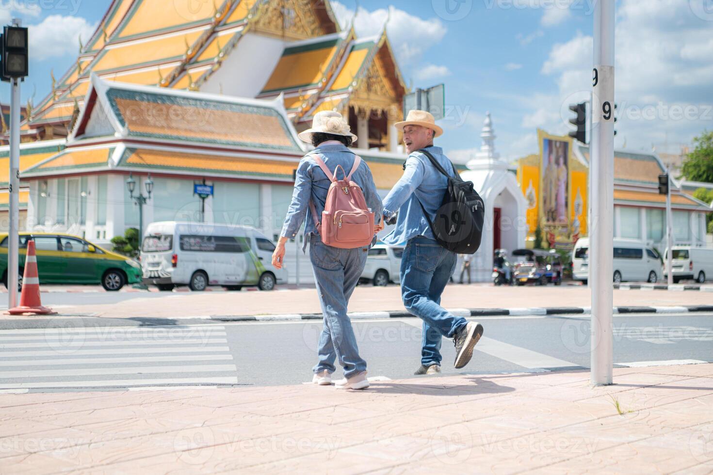 An elderly couple walks around the street in the old city of Bangkok, Thailand. photo