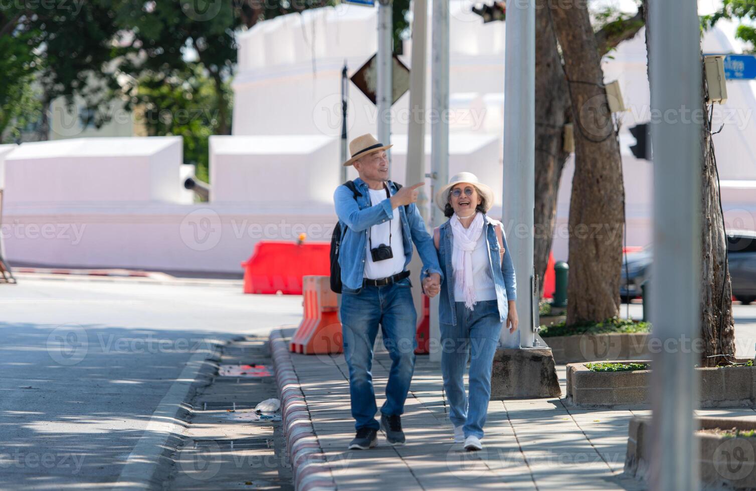 An elderly couple walks around the street in the old city of Bangkok, Thailand. photo