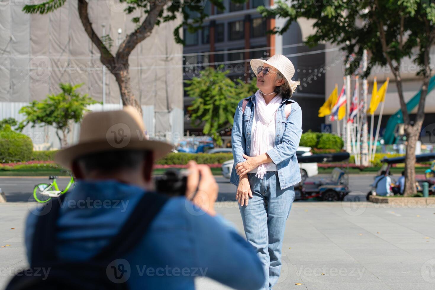 An elderly couple walks around the street in the old city of Bangkok, Thailand. photo