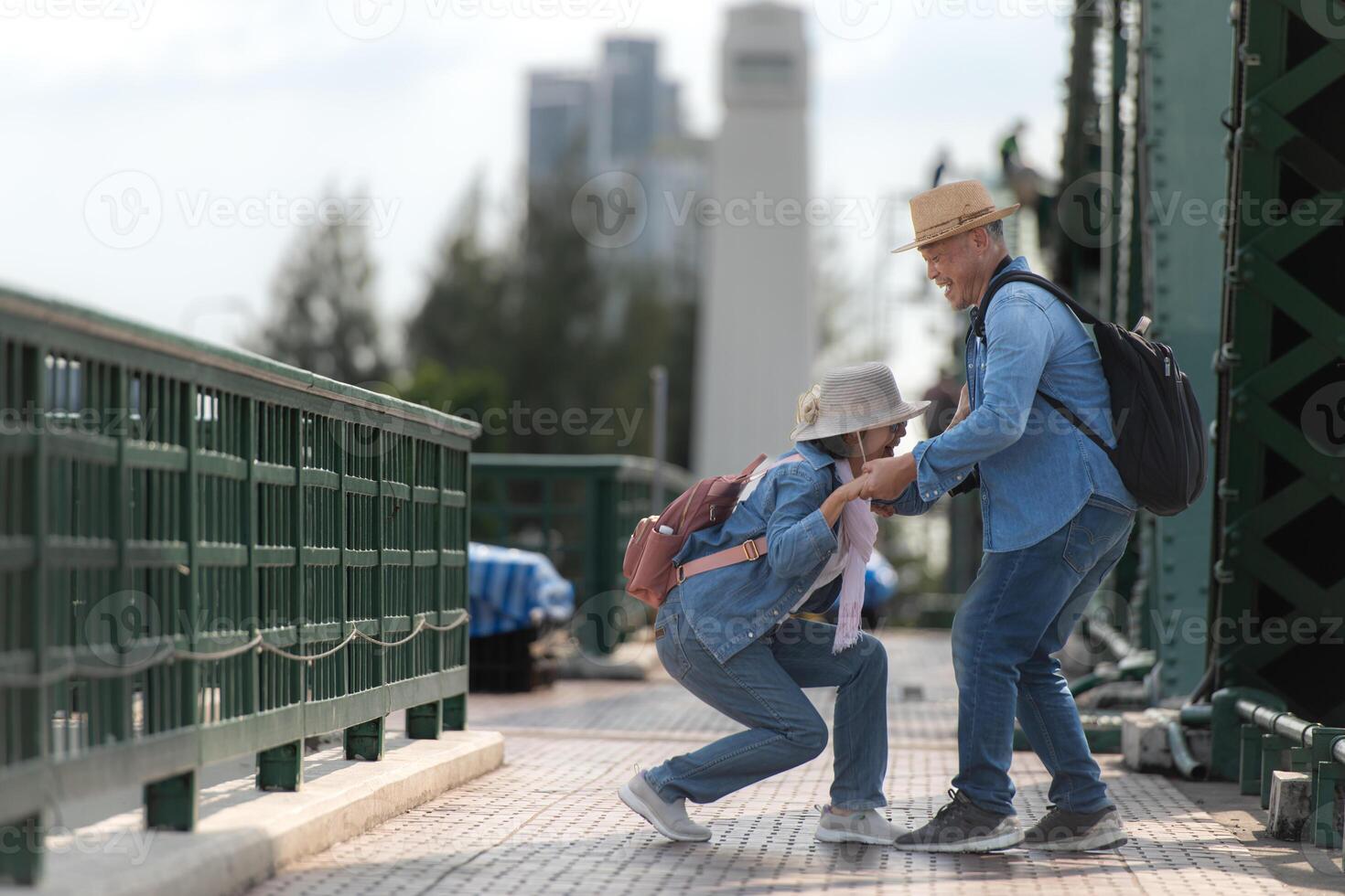 Elderly couples travel on the old iron bridge in Bangkok, Thailand photo
