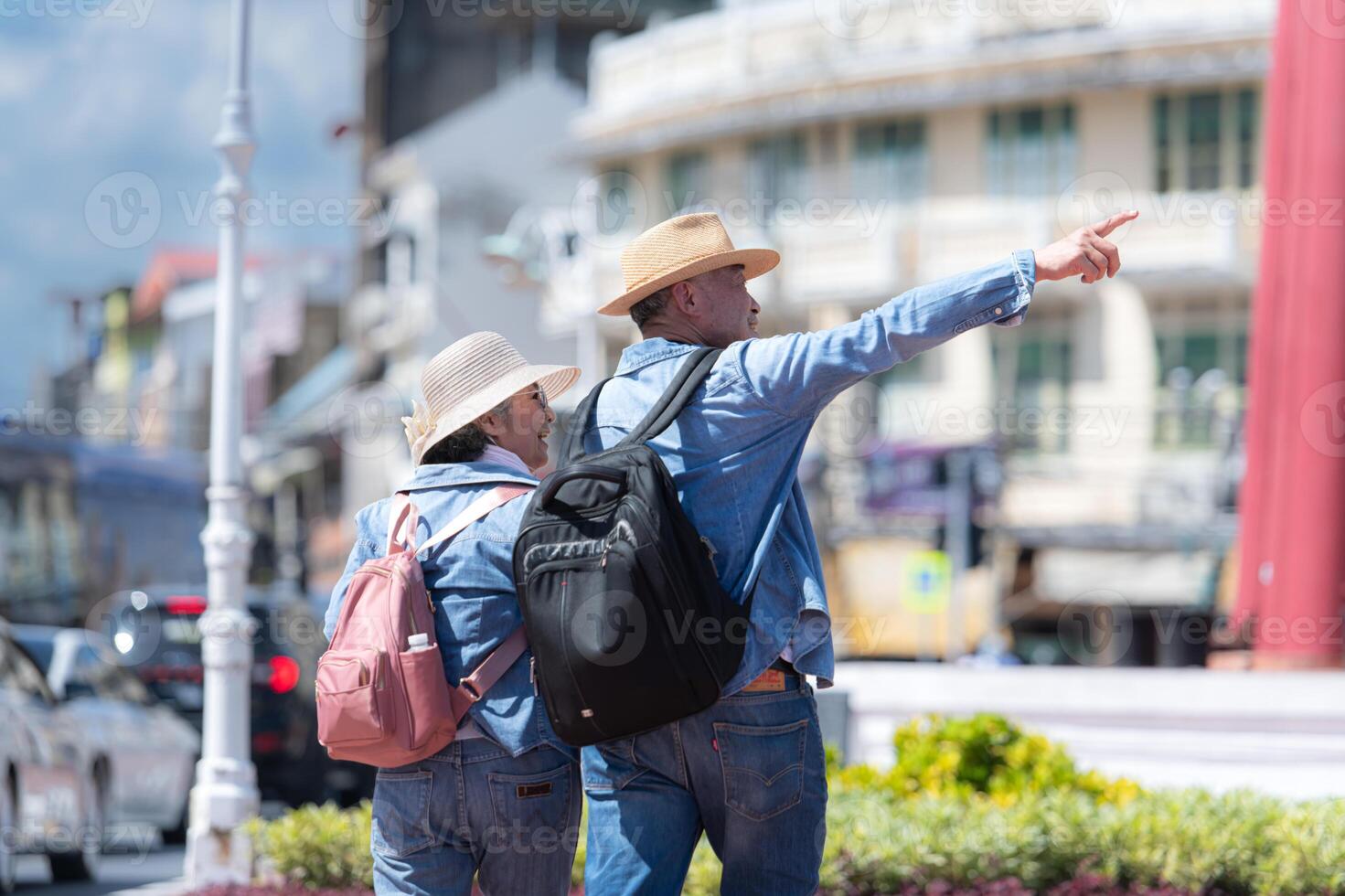 An elderly couple walks around the street in the old city of Bangkok, Thailand. photo