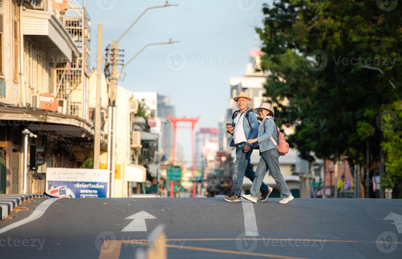 An elderly couple walks around the street in the old city of Bangkok, Thailand. photo