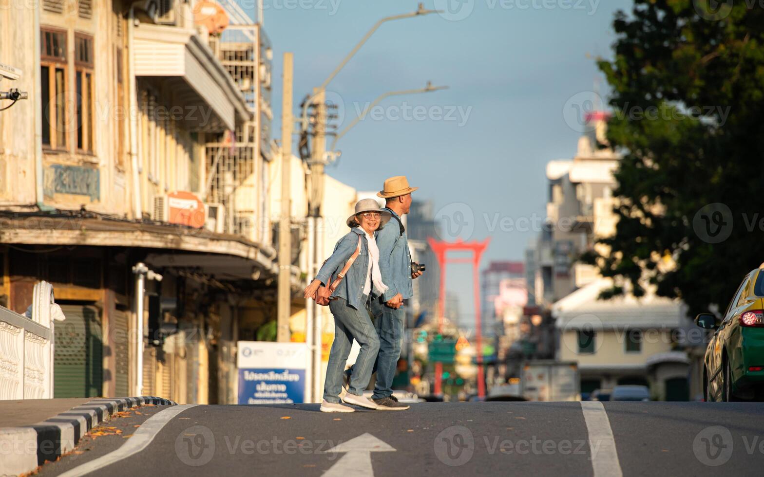 An elderly couple walks around the street in the old city of Bangkok, Thailand. photo