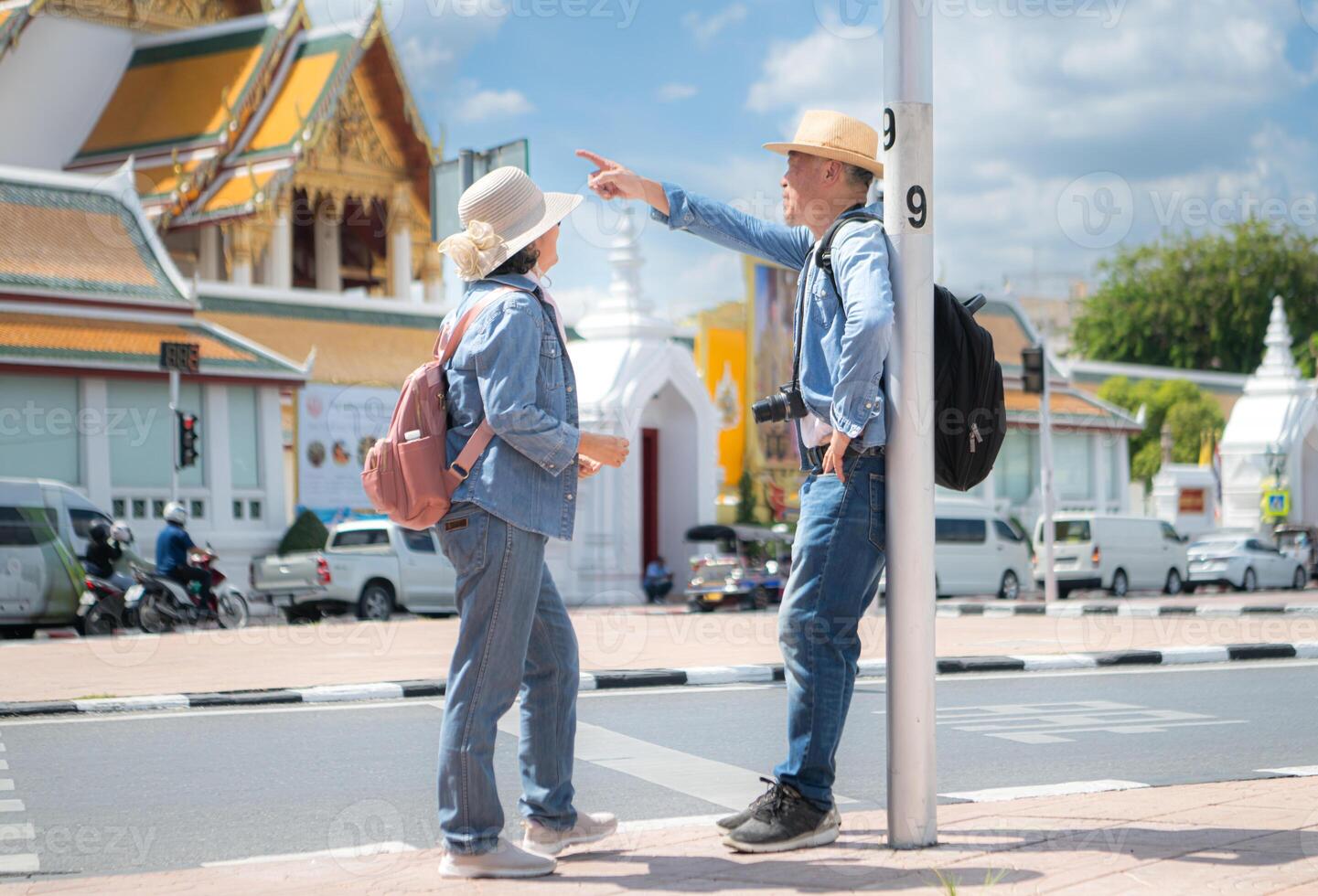An elderly couple walks around the street in the old city of Bangkok, Thailand. photo