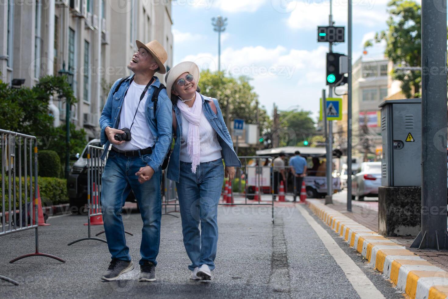 An elderly couple walks around the street in the old city of Bangkok, Thailand. photo