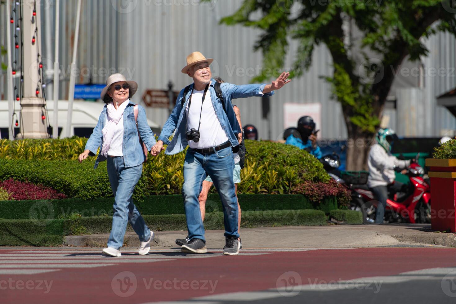 An elderly couple walks around the street in the old city of Bangkok, Thailand. photo
