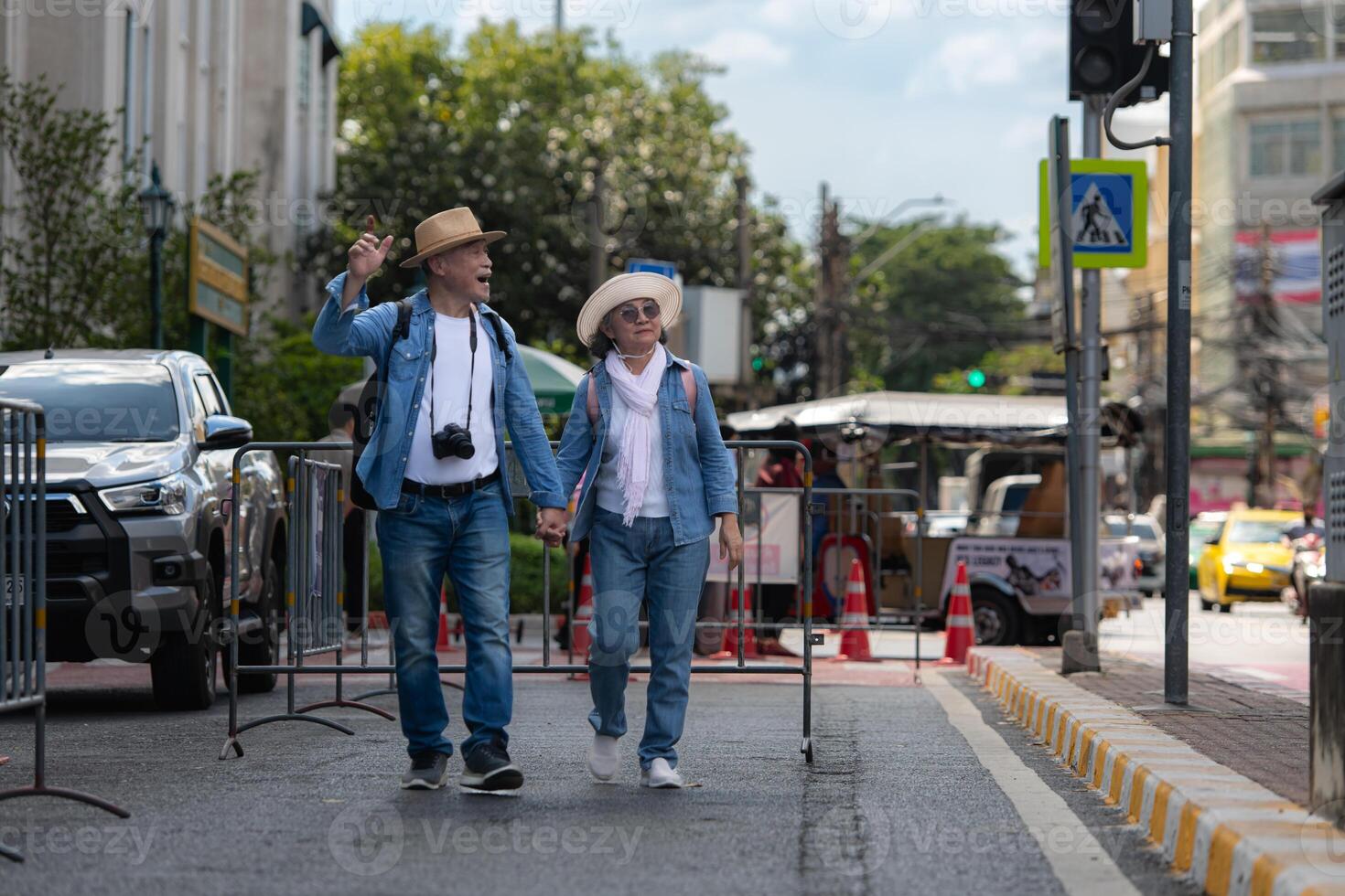 An elderly couple walks around the street in the old city of Bangkok, Thailand. photo