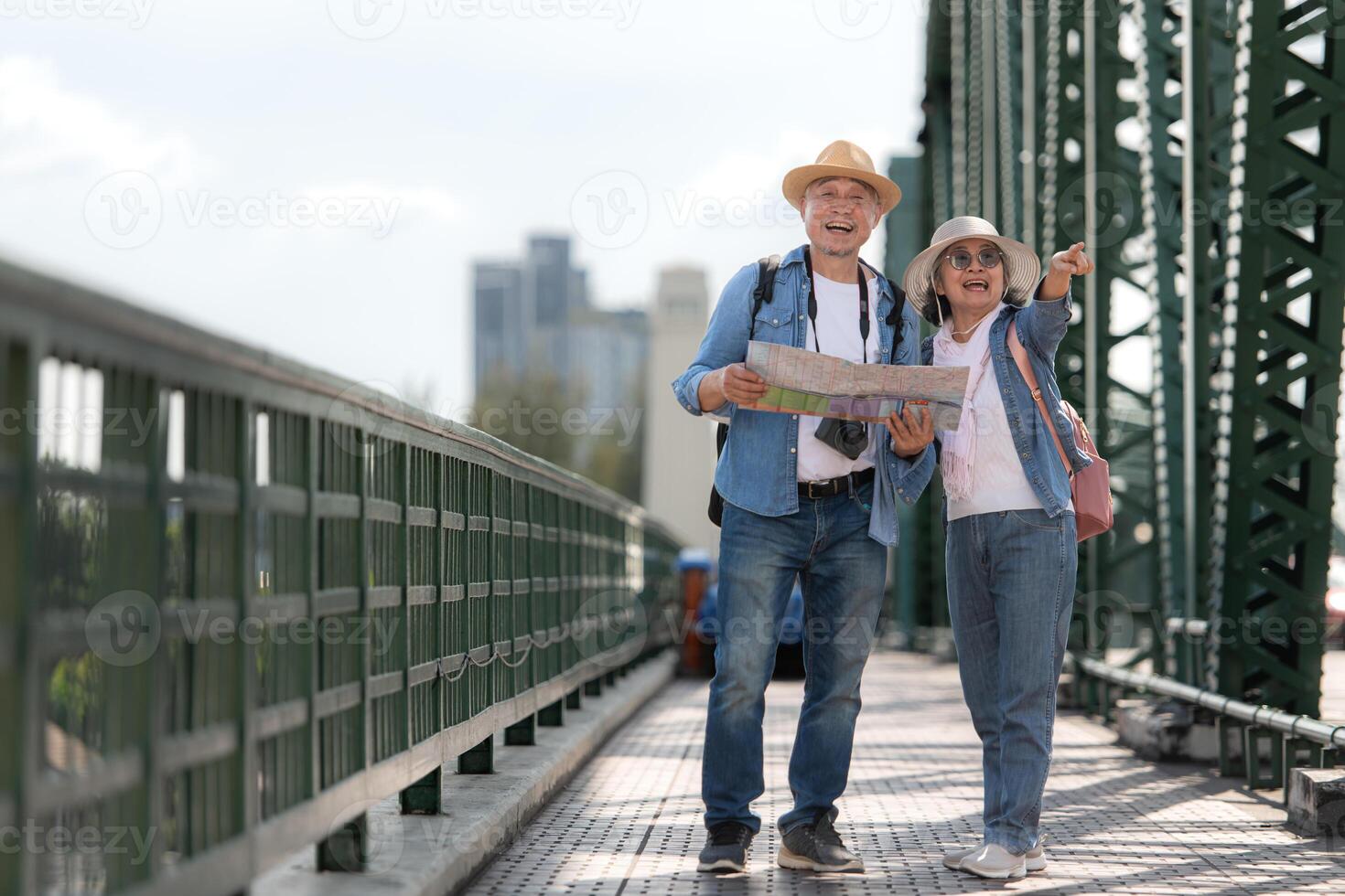 Elderly couples travel on the old iron bridge in Bangkok, Thailand photo