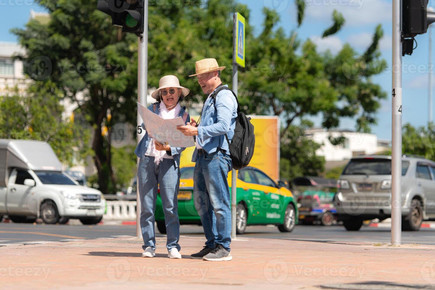 An elderly couple walks around the street in the old city of Bangkok, Thailand. photo