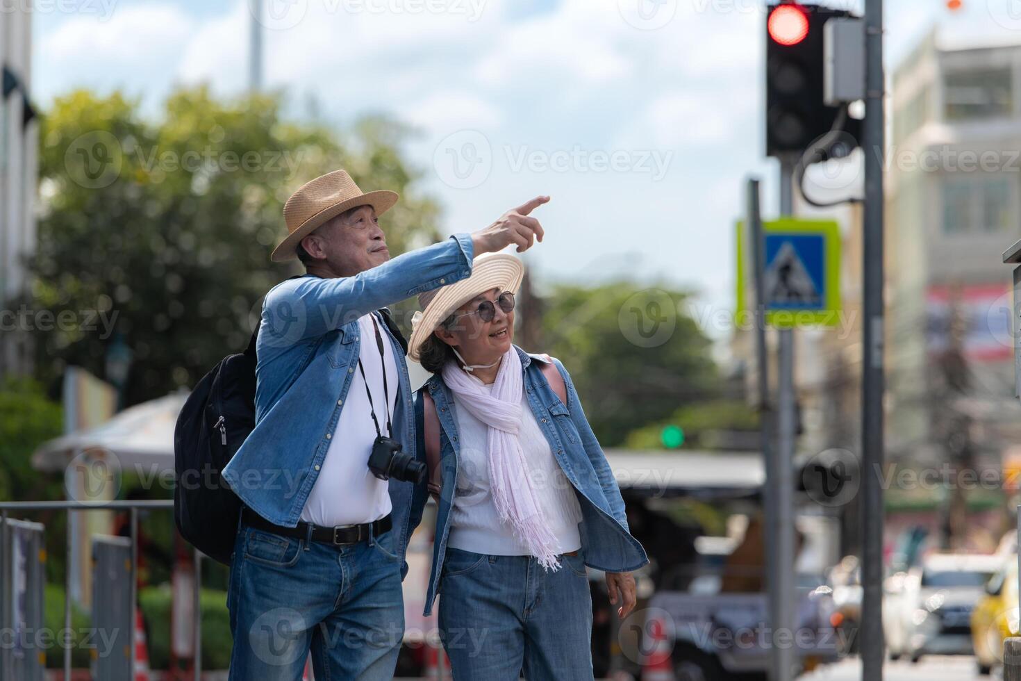 An elderly couple walks around the street in the old city of Bangkok, Thailand. photo