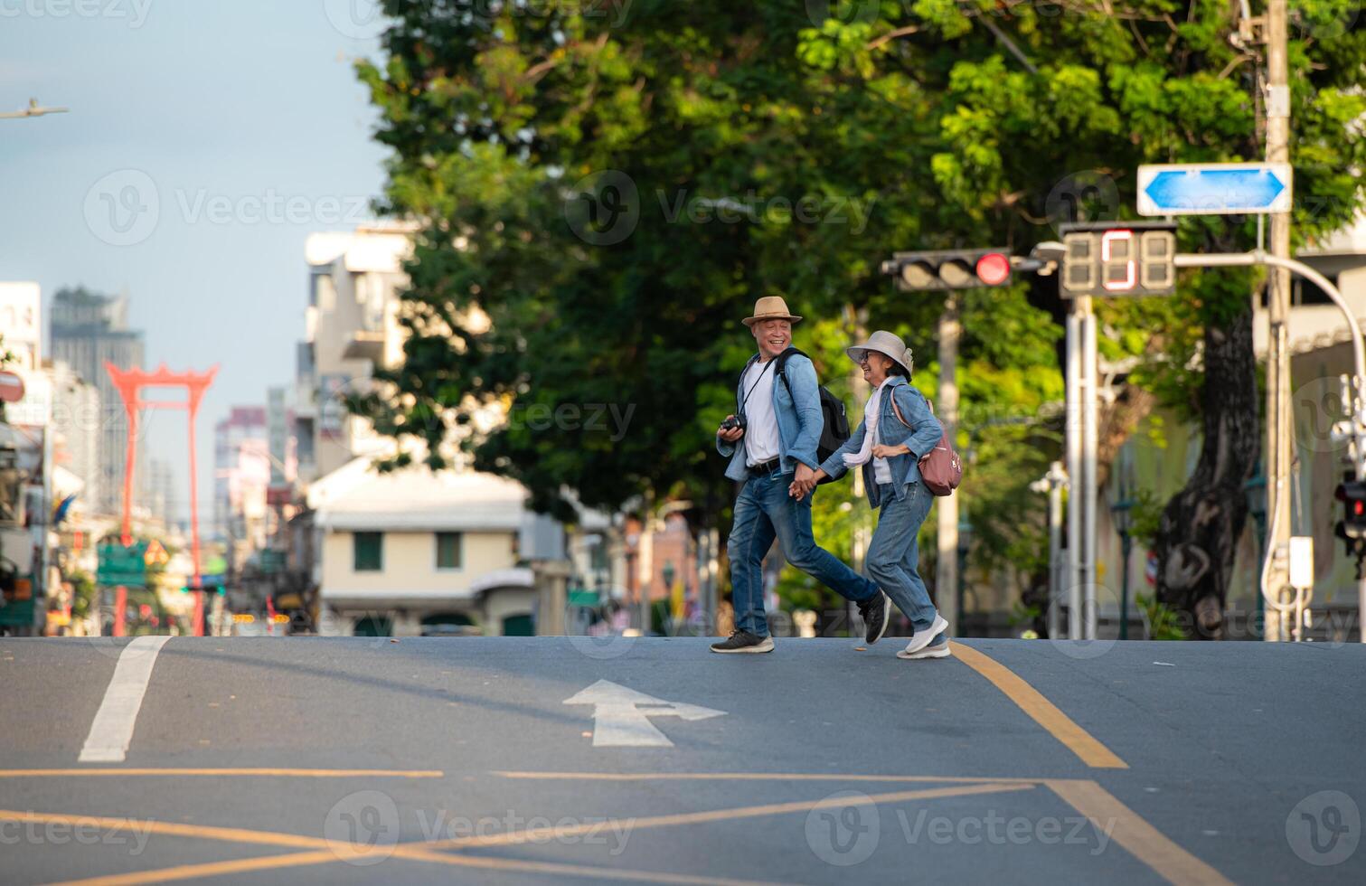 An elderly couple walks around the street in the old city of Bangkok, Thailand. photo
