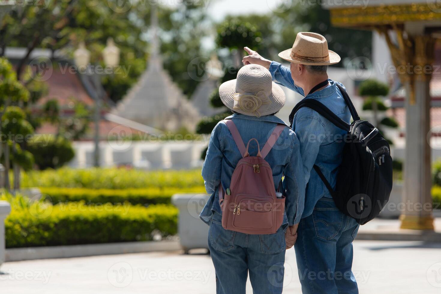 An elderly couple walks around the street in the old city of Bangkok, Thailand. photo