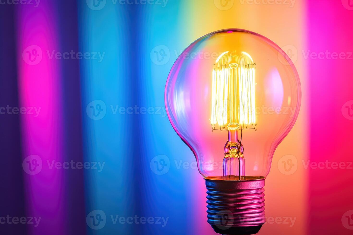Glowing Light Bulb Against Colorful Background photo