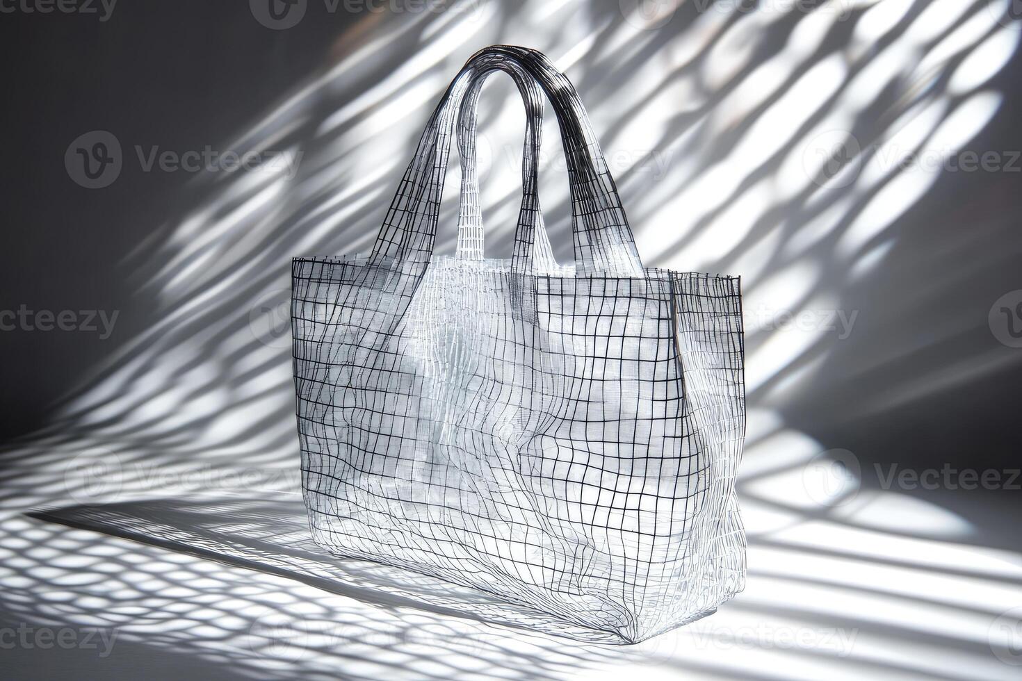 A Transparent Gridded Tote Bag Casts a Shadow in the Sunlight photo