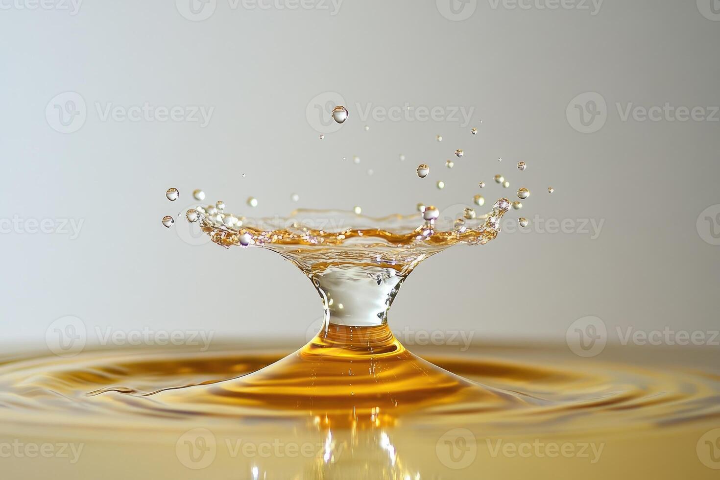 Water Drop Impact Creating a Golden Crown Splash photo