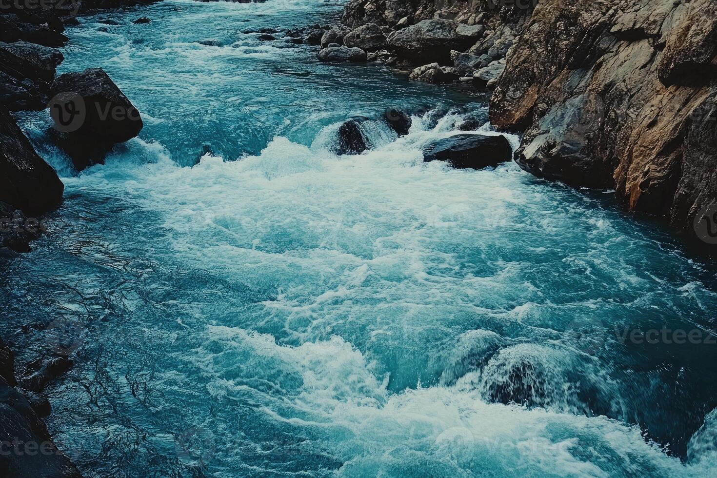 Turquoise Water Rapidly Flows Through a Rocky Gorge photo