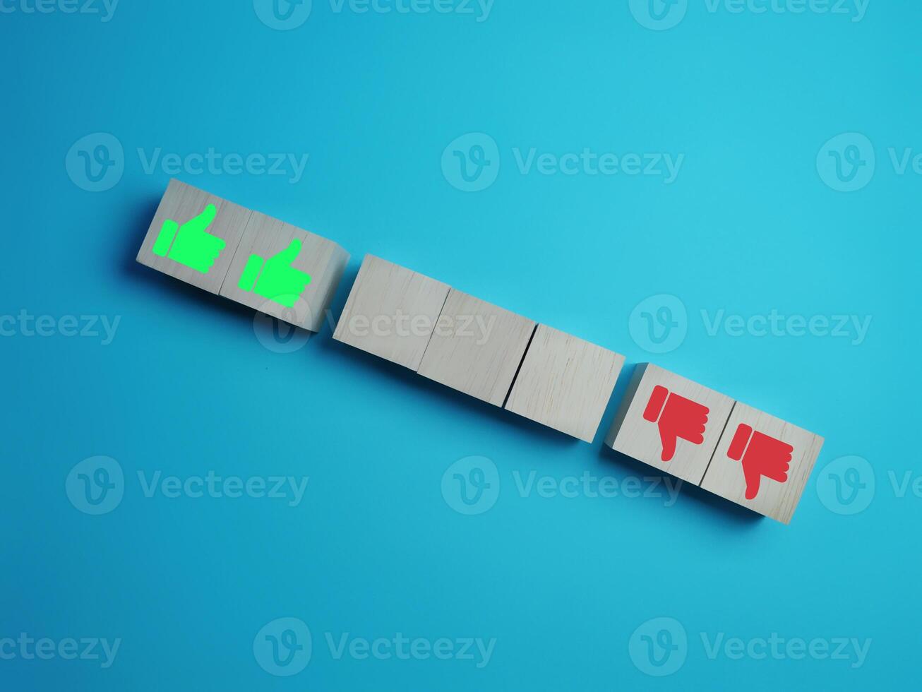 Like and dislike, thumbs up and down on empty wooden block photo